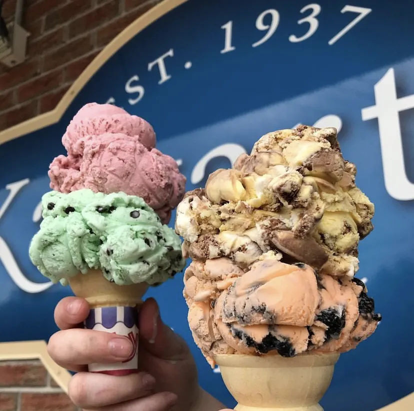 Strawberry and vanilla scoops in a waffle cone